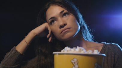 Woman watching a boring movie at the cinema